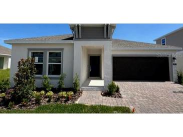 Charming single-story home with a dark garage door, neutral paint, and a well-manicured lawn at 4812 Worchester Dr, Kissimmee, FL 34746