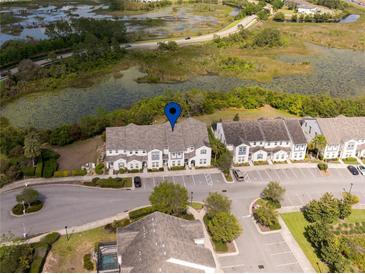 Scenic aerial view of townhomes and surrounding natural Florida landscape with ponds and lush greenery at 510 Captiva Dr, Davenport, FL 33896