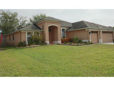 Charming single-story home with well-manicured lawn and tasteful landscaping at 742 Chamberlin Trl, St Cloud, FL 34772