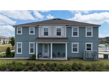 Inviting home exterior showcasing a cozy front porch and tidy landscaping at 11713 Tidal Alley Trl, Orlando, FL 32832