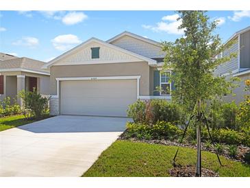 Charming single-story home with a two-car garage, well-manicured lawn, and tasteful landscaping at 6389 Clover St, Lake Hamilton, FL 33851