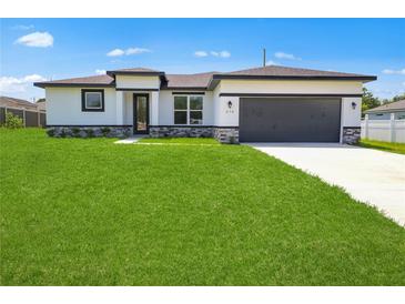 Charming single-story home with a well-manicured lawn and stone accents at 370 Marion Oaks Crse, Ocala, FL 34473