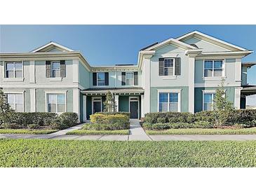Inviting townhome with manicured lawn, complemented by neat landscaping and a bright, sunny sky at 4710 Nathan Hale Blvd, St Cloud, FL 34769