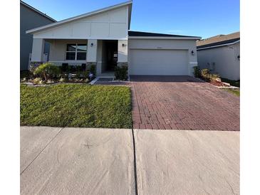 Beautiful single Gathering home with well maintained lawn, landscaping, and brick driveway at 9083 Coral Cape St, Kissimmee, FL 34747