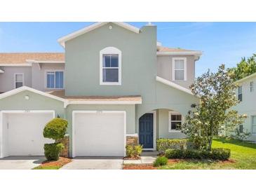 Charming two-story home with a well-maintained lawn and attached one-car garage at , Kissimmee, FL 34744