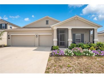 Charming one-story home with a three-car garage, inviting porch, and beautiful landscaping at 109 Pineywoods St, St Cloud, FL 34772