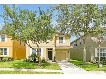 Charming two-story home with well-maintained lawn and mature landscaping at 8904 Candy Palm Rd, Kissimmee, FL 34747