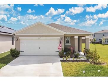 Charming one-story home with a two car garage and manicured lawn at 1507 Bitteroot St, Kissimmee, FL 34744