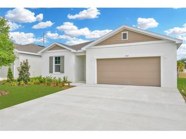 Charming single-Gathering home with a well-manicured lawn and a two-car garage, freshly painted with attractive exterior at 1747 Carnelian St, Deland, FL 32720