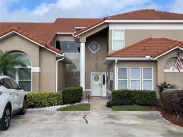 Charming home featuring a well-manicured lawn and a welcoming front entrance with a decorative wreath at 1750 Saint Tropez Ct, Kissimmee, FL 34744