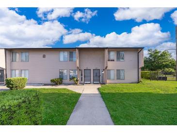 Two-story condo featuring well-maintained landscaping and inviting curb appeal at 2031 Ludlow Ln # 3303, Orlando, FL 32839