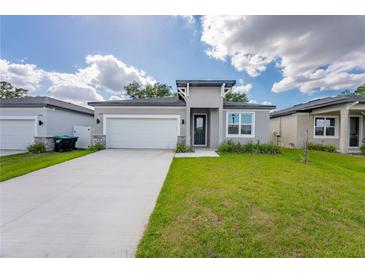 Beautiful single-story home featuring a well-manicured lawn and attached two-car garage at 2872 Lingo Ln, Orlando, FL 32822