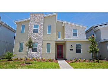 Charming two-story home with a stone accent wall and well-maintained landscaping at 4213 Paragprah St, Kissimmee, FL 34746