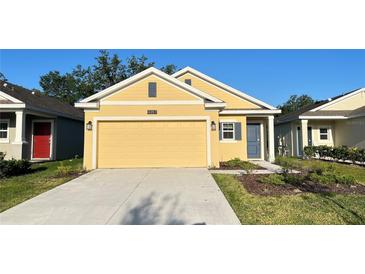 Charming single-Gathering home with a two-car garage, a well-manicured lawn and clean walkway at 4357 Babbling Brook Way, Kissimmee, FL 34746