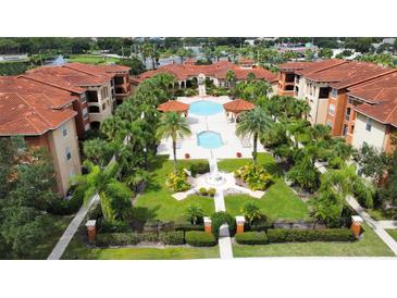 Beautiful aerial view showcasing the community pool and lush landscaping in a tropical setting at 5560 Metrowest Nw Blvd # 106, Orlando, FL 32811