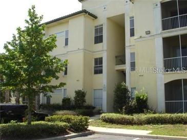 A well-maintained apartment building with lush landscaping and ample parking at 8907 Legacy Ct # 14 205, Kissimmee, FL 34747