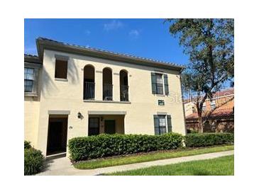 Charming two-story home with arched balconies and manicured landscaping at 1000 Via Santae Ln # 201, Kissimmee, FL 34747
