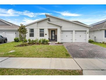 Charming single-story home with a well-manicured lawn and attached two-car garage at 18863 Rawson St, Orlando, FL 32827