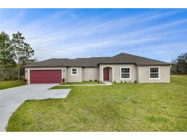 Charming single-story home with a well-maintained lawn, red garage door, and neutral stucco at 250 Beckenham Dr, Kissimmee, FL 34758