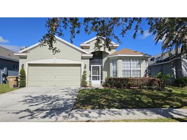 Charming single-Gathering home with a well-manicured lawn and mature landscaping at 2713 Barnsley Ln, Kissimmee, FL 34744
