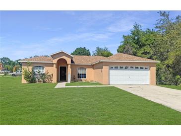 Charming single-story home with a well-maintained lawn, two-car garage, and neutral color scheme at 36 Inconnu Dr, Poinciana, FL 34759