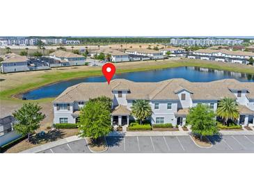 Community aerial view showcasing a stunning lakeside townhome with tile roof at 4907 Romeo Cir, Kissimmee, FL 34746