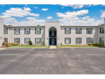 Exterior of condominium complex with blue shutters and a well-maintained parking lot at 1038 Plantation Dr # D9, Kissimmee, FL 34741