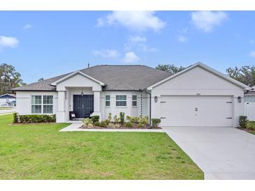Beautiful single Gathering home with a two car garage and landscaped front yard at 1083 Snively Cir, Lake Hamilton, FL 33851