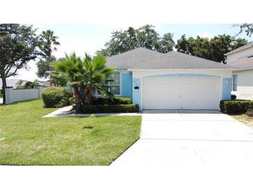 Charming single-story home with well-manicured lawn and mature landscaping at 1301 Rebecca Dr, Haines City, FL 33844
