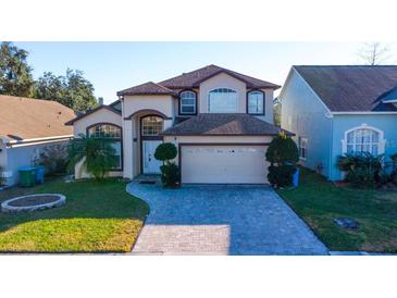 Charming two-story home featuring an attached two-car garage and a meticulously maintained front yard at 2110 Korat Ln, Maitland, FL 32751
