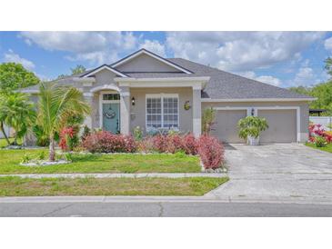 Charming single-Gathering home featuring a well-manicured lawn and a three-car garage at 3191 Marshfield Preserve Way, Kissimmee, FL 34746