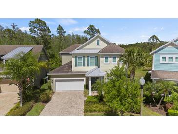 Inviting two-story home with a two-car garage and charming landscaping at 8724 Peachtree Park Ct, Windermere, FL 34786