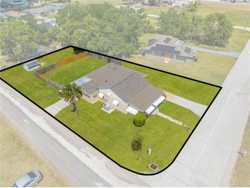 Aerial view of charming single Gathering home featuring a spacious fenced yard with mature trees at 1422 Missouri Ave, St Cloud, FL 34769