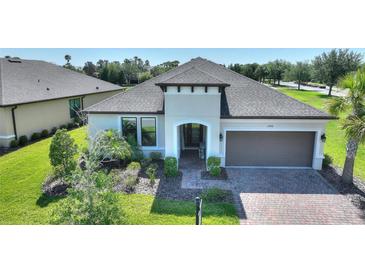 Charming single-story home featuring a two-car garage, well-maintained landscaping, and a brick-paved driveway at 1948 Molise Dr, Kissimmee, FL 34759