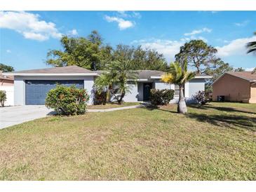 Charming single-story home with a well-maintained lawn and tidy landscaping at 218 Cranbrook Dr, Kissimmee, FL 34758