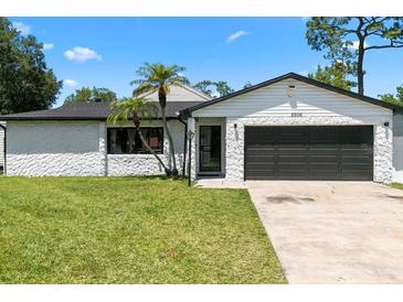 Charming single-story home featuring a well-maintained lawn and attached two-car garage at 2506 Bali Cir, Kissimmee, FL 34741