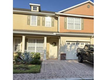 Charming two-story home featuring a well-manicured front yard, brick paved driveway, and attached garage at 3561 Sanctuary Dr, St Cloud, FL 34769