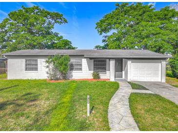 Charming single-story home with a well-manicured lawn and inviting curb appeal under a bright blue sky at 514 S Cottage Hill Rd, Orlando, FL 32805