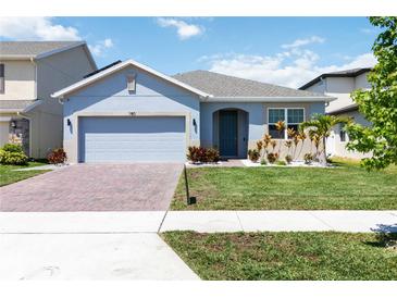 Charming single-Gathering home featuring a brick driveway and manicured front yard at 1180 Lone Palm Way, St Cloud, FL 34771