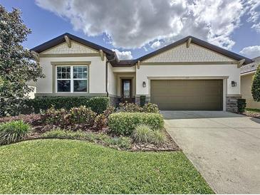 Beautiful one-story home featuring a manicured lawn and an attached two-car garage at 1271 Yorkshire Ct, Davenport, FL 33896