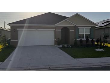 Charming single-story home with a two-car garage and well-maintained landscaping at 3041 Tobago Dr, Haines City, FL 33844