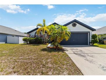 Charming home exterior with a well-manicured lawn and beautiful landscaping and a two car garage at 3111 Turnberry Blvd, Kissimmee, FL 34744