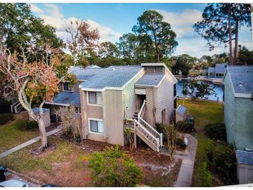 Aerial view of the home overlooking a lake and featuring a private stairwell at 6040 Peregrine Ave # A01, Orlando, FL 32819