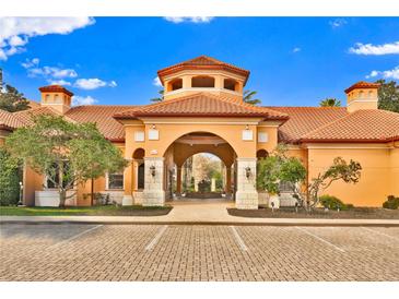 Community clubhouse boasts a terracotta tile roof, barrel-vaulted entry, and a covered walkway to interior courtyard at 6141 Metrowest Blvd # 303, Orlando, FL 32835