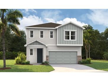 Charming two-story home featuring a modern design, two-car garage, and beautifully landscaped yard at 824 Lake Dell Rd, Dundee, FL 33838