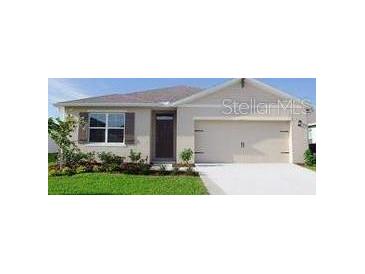 Charming single-story home with a well-manicured lawn, attached garage and inviting front entrance at 1104 Star Ruby Ln, Winter Haven, FL 33880