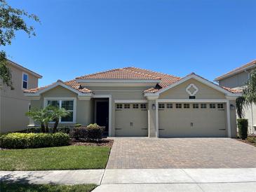 Charming one-story home featuring a tile roof, well-manicured landscaping, and a spacious two-car garage at 1116 Blackwolf Run Rd, Davenport, FL 33896