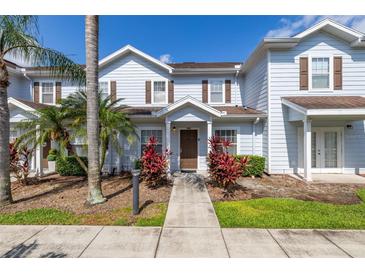 Charming townhome with a landscaped front yard and covered entrance at 2903 Edenshire Way # 103, Kissimmee, FL 34746
