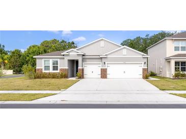 Charming single-Gathering home featuring a two-car garage, stone accents, and well-maintained lawn at 348 Conway Ave, St Cloud, FL 34771