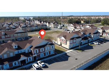 A beautiful aerial view of the resort's vibrant townhouse community with ample parking spaces available at 7562 Sunflower Cir, Kissimmee, FL 34747